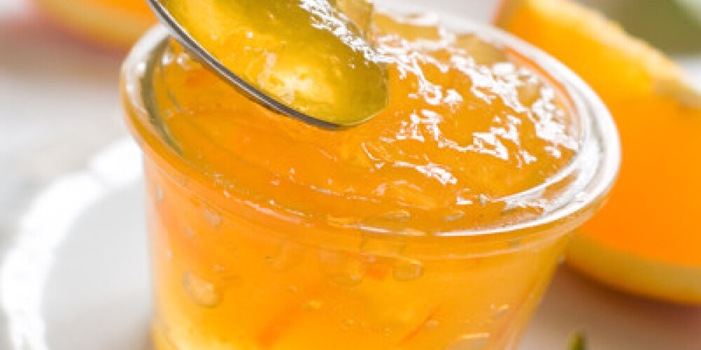Citrus jam in glass jar, selective focus