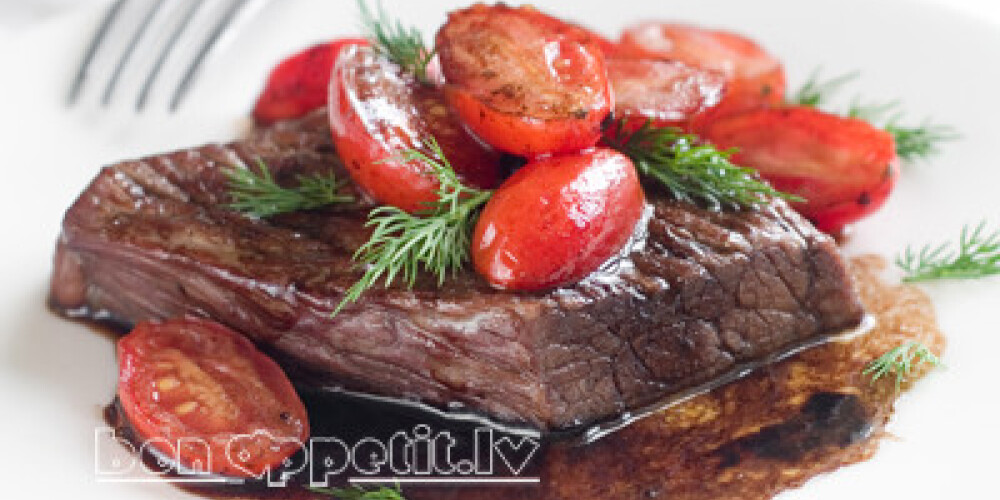 Beef steak with roasted tomato, selective focus