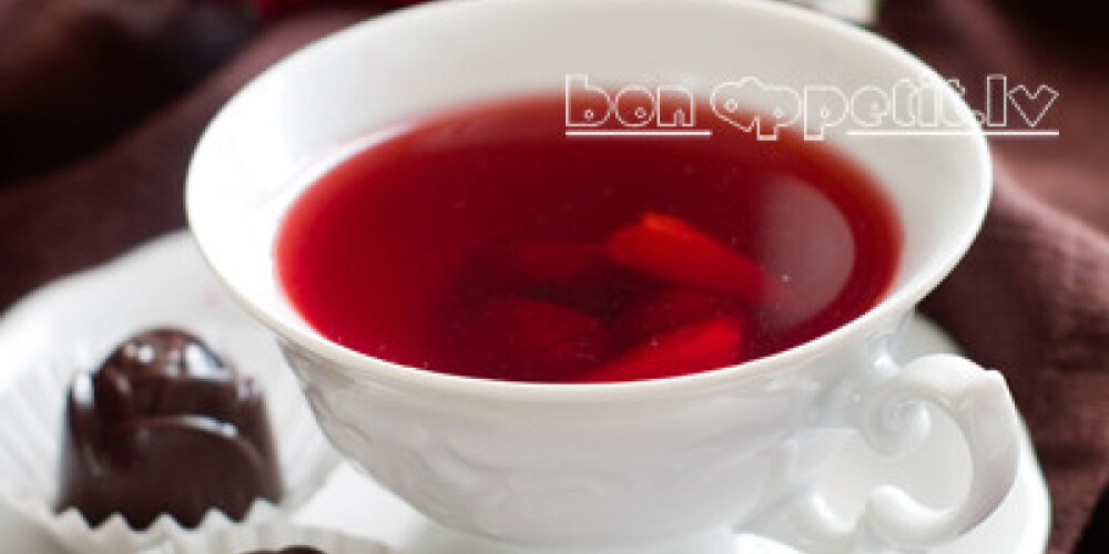 A cup of fruit tea with chocolate candy, selective focus