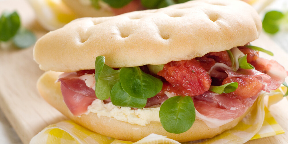 Sandwich with prosciutto, tomato and cheese, selective focus