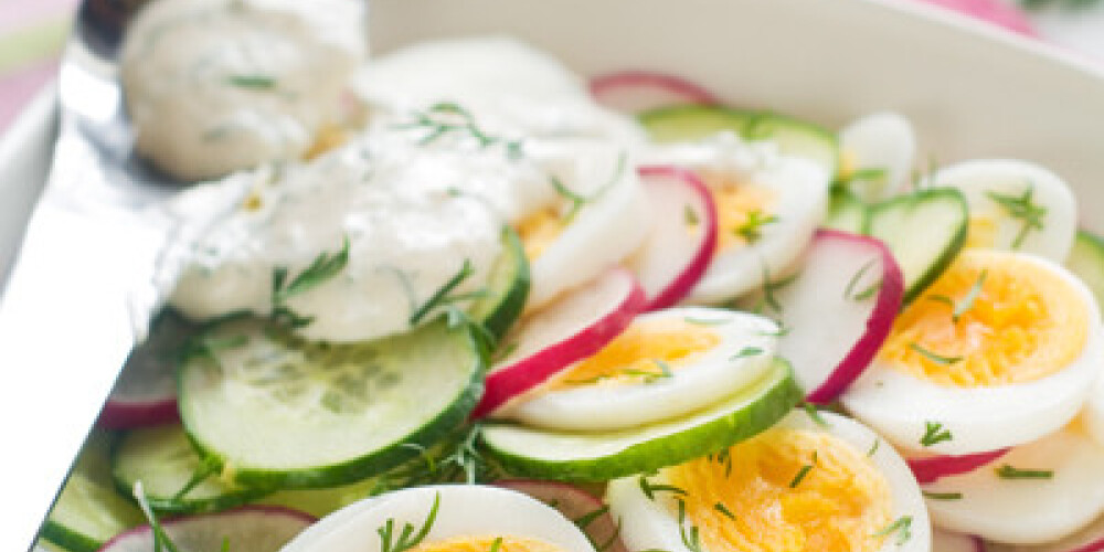 Salad with cucumber, radish and egg, selective focus