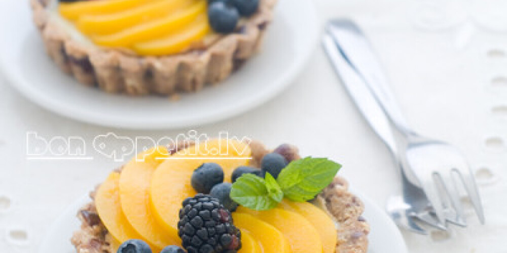 A fresh berry tart on white background, selective focus