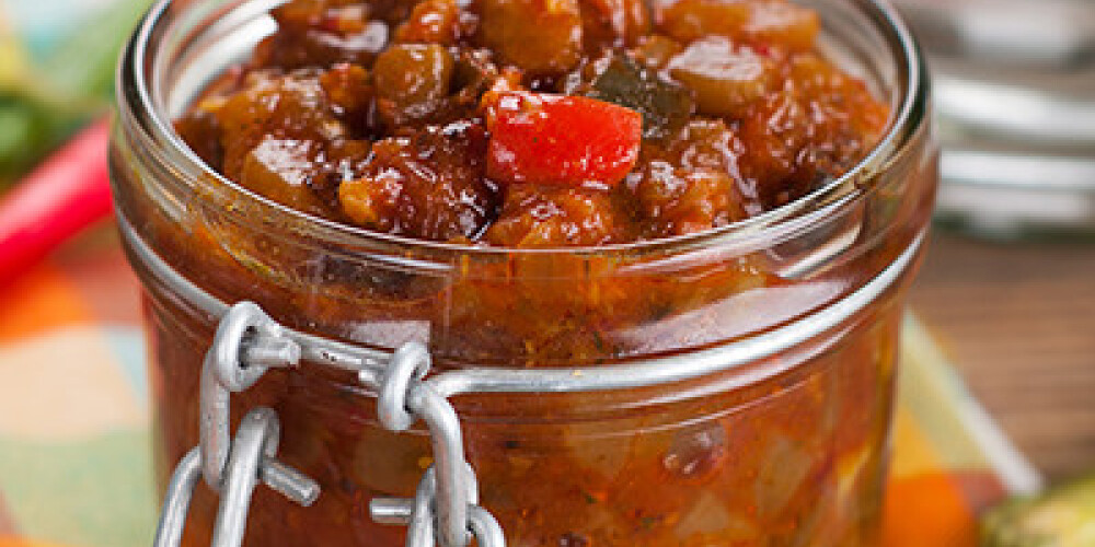 Tomato, pepper, eggplant and zucchini preserves in glass jar, selective focus