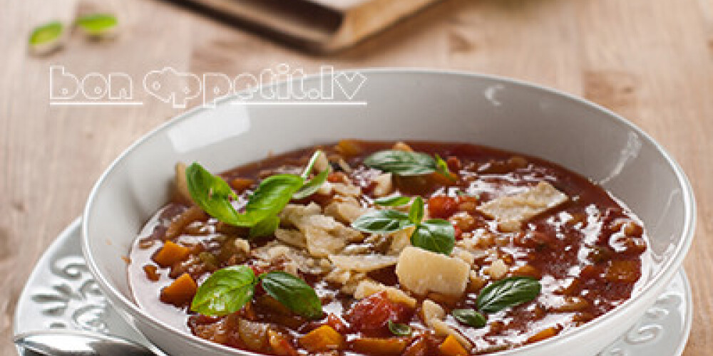 Minestrone soup with cheese and basil, selective focus