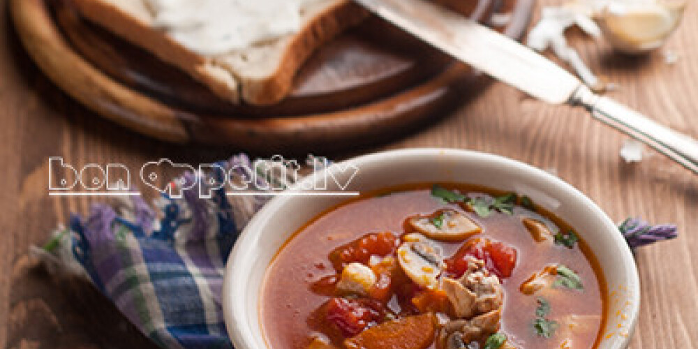 Vegetable soup with tomato on wooden background, selective focus