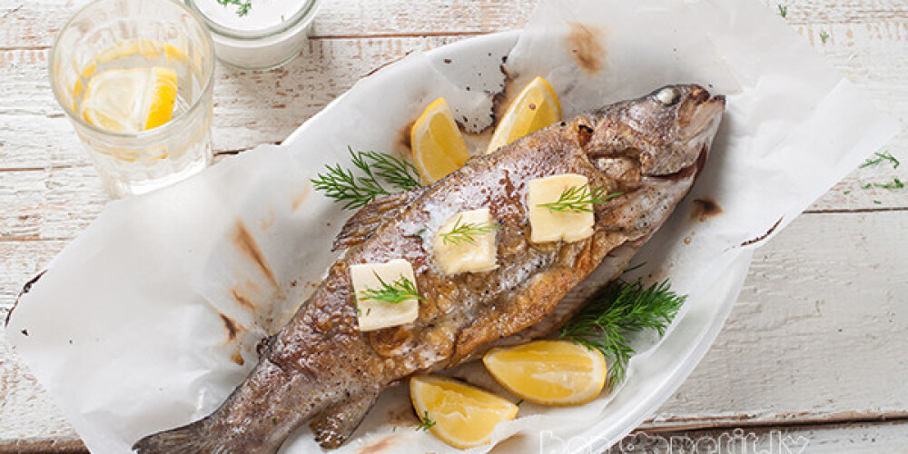 Grilled fish with butter and lemon, selective focus