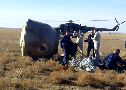 Specialists and rescuers gather near the Soyuz capsule transporting U.S. astronaut Nick Hague and Russian cosmonaut Alexei Ovchinin, after it made an emergency landing following a failure of its booster rockets, near the city of Zhezkazgan in central Kazakhstan October 11, 2018. Federal Air Transport Agency "Rosaviation"/Handout via REUTERS. ATTENTION EDITORS - THIS PICTURE WAS PROVIDED BY A THIRD PARTY. NO RESALES. NO ARCHIVES.