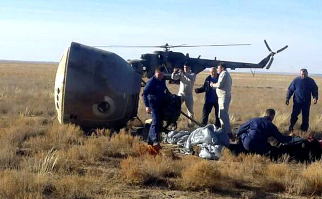 Specialists and rescuers gather near the Soyuz capsule transporting U.S. astronaut Nick Hague and Russian cosmonaut Alexei Ovchinin, after it made an emergency landing following a failure of its booster rockets, near the city of Zhezkazgan in central Kazakhstan October 11, 2018. Federal Air Transport Agency "Rosaviation"/Handout via REUTERS. ATTENTION EDITORS - THIS PICTURE WAS PROVIDED BY A THIRD PARTY. NO RESALES. NO ARCHIVES.