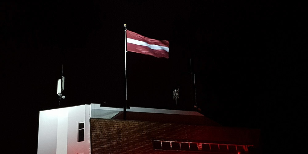 Virs bobsleja un kamaniņu trases "Sigulda" pacelts monumentāls Latvijas karogs