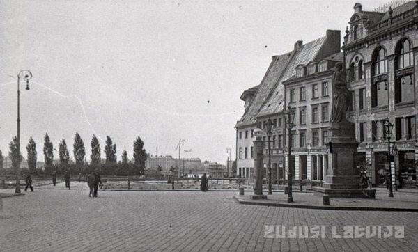 Rīgas Rātslaukums (ap 1930. gadu) aiz Rolanda statujas, iepretim Melngalvju namam, redzams “Shell” benzīna uzpildes automāts.