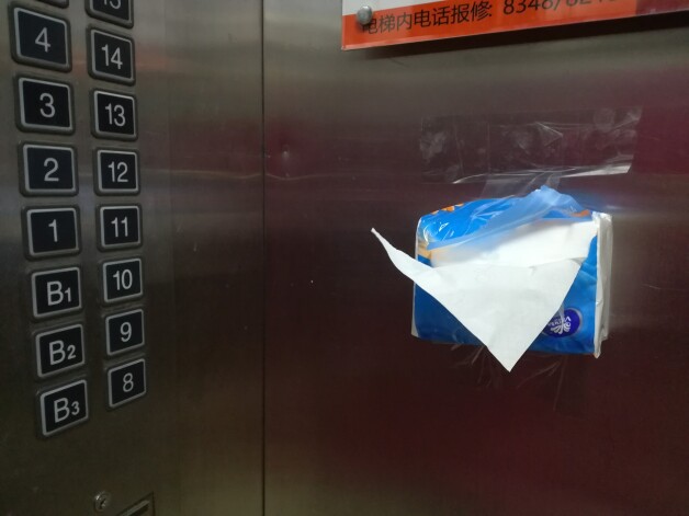 Universitātes kopmītņu liftā ir uzliktas salvetes, lai lifta pogas netiktu spiestas ar kailām rokām, tādejādi samazinot inficēšanās risku ar bīstamo vīrusu.