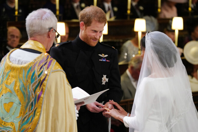 WINDSOR, UNITED KINGDOM - MAY 19:  Prince Harry places the wedding ring on the finger of Meghan Markle during their wedding service, conducted by the Archbishop of Canterbury Justin Welby in St George's Chapel at Windsor Castle on May 19, 2018 in Windsor, England. (Photo by Jonathan Brady - WPA Pool)