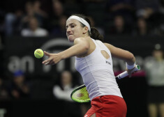 Latvia's Anastasija Sevastova winds up to hit a ball into the stands after defeating United States' Serena Williams in a Fed Cup qualifying tennis match Saturday, Feb. 8, 2020, in Everett, Wash. (AP Photo/Elaine Thompson)