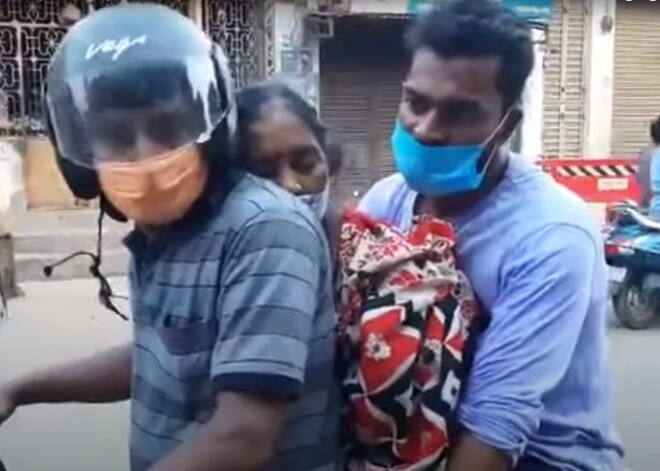 Страшные кадры: в Индии сын вез тело матери на мотоцикле, потому что не осталось свободных скорых
