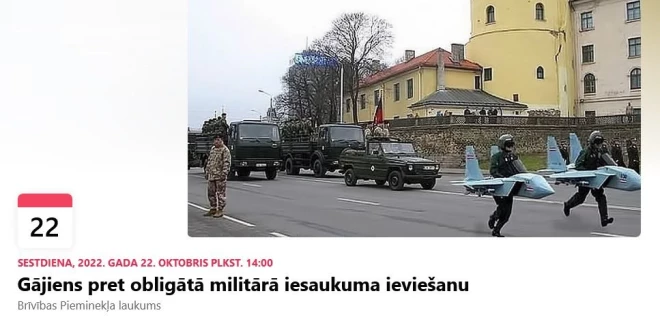 Šādi sākotnēji izskatījās gājiena lapa "Facebook" - ar diviem lidmašīnu maketos ietērptiem personāžiem, kuri "uzlīmēti" pa virsu fotogrāfijai ar NBS parādi 11. novembra krastmalā. Tas esot bijis "memčiks", nevis "feiks", skaidro gājienu rīkojošās kopas pārstāvji.