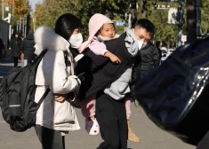 A man carries a child as they leave a children's hospital in Beijing, Friday, Nov. 24, 2023. Chinese officials say they did not detect any "unusual or novel diseases" in the country, the World Health Organization said Thursday, following an official request by the U.N. health agency for information about a potentially worrying spike in respiratory illnesses and clusters of pneumonia in children. (AP Photo/Ng Han Guan)  XHG102