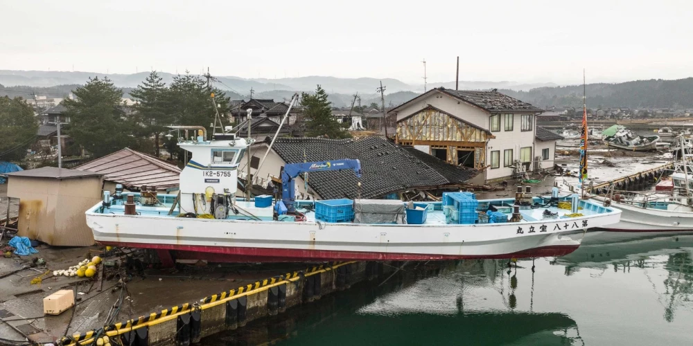 TOPSHOT - A ship washed ashore is pictured in the city of Suzu, Ishikawa prefecture on January 3, 2024, after a major 7.5 magnitude earthquake struck the Noto region in Ishikawa prefecture on New Year's Day. Japanese rescuers scrambled to search for survivors on January 3 as authorities warned of landslides and heavy rain after a powerful earthquake that killed at least 62 people. (Photo by Fred MERY / AFP)