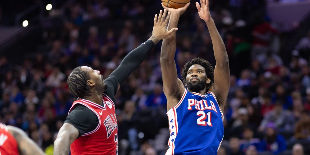 Jan 2, 2024; Philadelphia, Pennsylvania, USA; Philadelphia 76ers center Joel Embiid (21) shoots the ball past Chicago Bulls center Andre Drummond (3) during the second quarter at Wells Fargo Center. Mandatory Credit: Bill Streicher-USA TODAY Sports