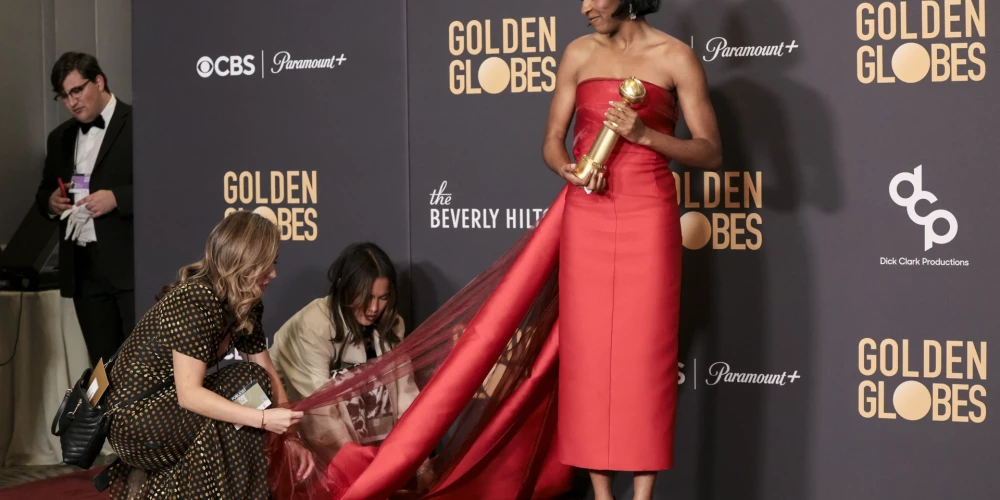 epa11063516 US actor Ayo Edebiri has her dress adjusted as she holds the Golden Globe award for Best Performance by a Female Actor in a Television Series - Musical or Comedy for 'The Bear' in the press room during the 81st annual Golden Globe Awards ceremony at the Beverly Hilton Hotel in Beverly Hills, California, USA, 07 January 2024. Artists in various film and television categories are awarded Golden Globes by the Hollywood Foreign Press Association.  EPA/ALLISON DINNER