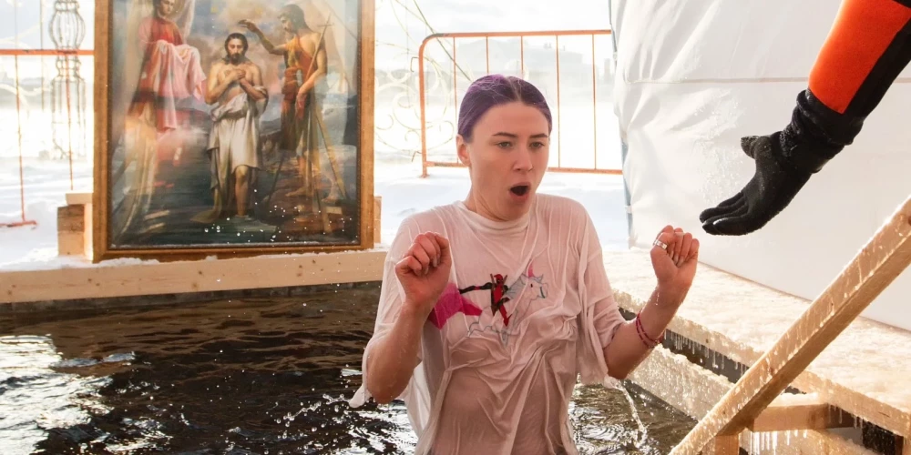 A young woman is seen during Epiphany bathing in a font on the territory of the Peter and Paul Fortress in St. Petersburg. Russia celebrates one of the main Christian holidays - Epiphany. Thousands of believers throughout Russia plunge into the font, despite the severe frost in the country. (Photo by Artem Priakhin / SOPA Images/Sipa USA)