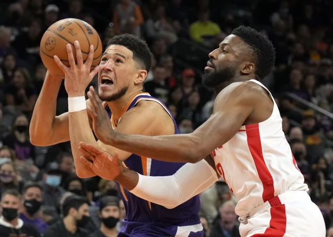 Feb 16, 2022; Phoenix, Arizona, USA; Phoenix Suns guard Devin Booker (1) drives past Houston Rockets forward David Nwaba (2) at Footprint Center. Mandatory Credit: Rick Scuteri-USA TODAY Sports