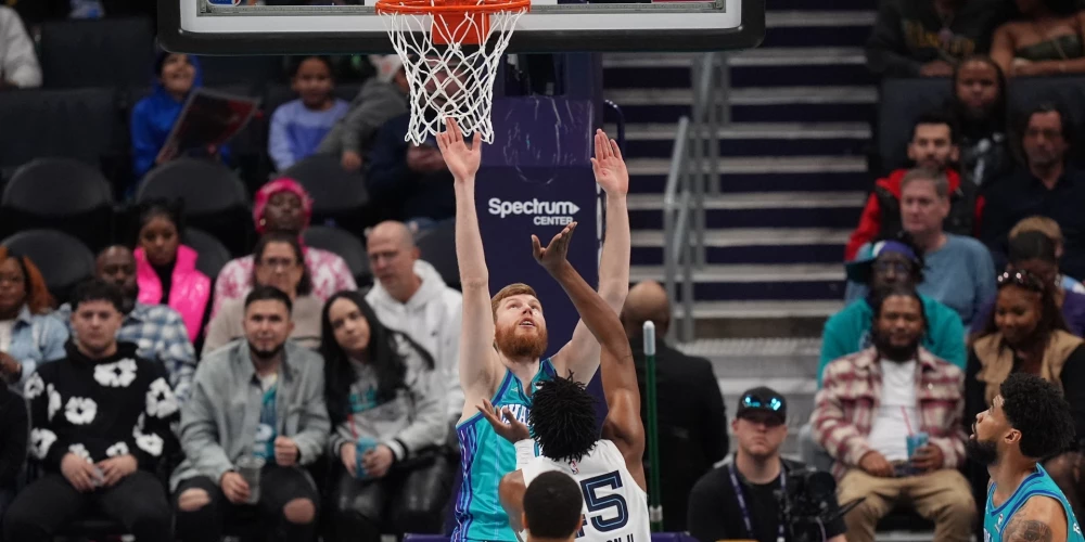 Feb 10, 2024; Charlotte, North Carolina, USA; Charlotte Hornets forward Davis Bertans (9) tries to block a shot by Memphis Grizzlies center Trey Jemison (55) during the second quarter at Spectrum Center. Mandatory Credit: Jim Dedmon-USA TODAY Sports