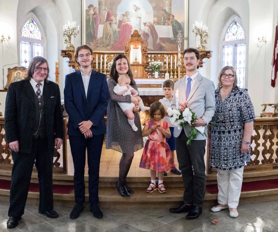 Ģimene kuplā pulkā Justīnes jaunākā dēla Luija kristībās Sv. Magdalēnas baznīcā 2023. gada vasarā.