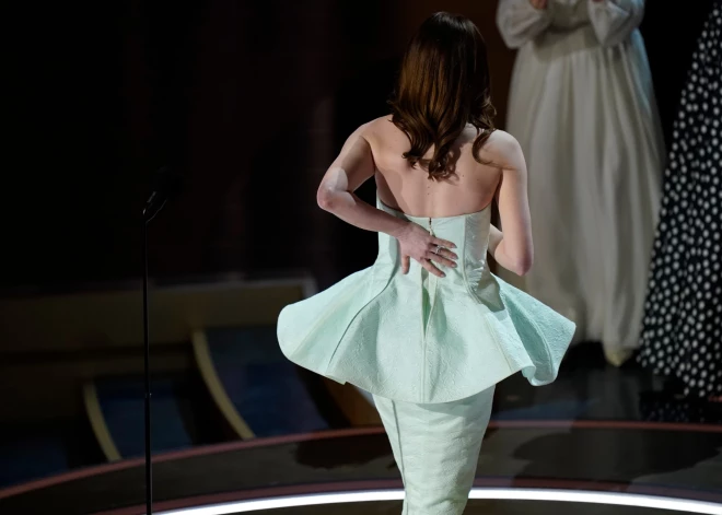 Emma Stone holds her dress as she walks of stage after accepting the award for best actress in a leading role for her role in \"Poor Things\" during the 96th Oscars at the Dolby Theatre at Ovation Hollywood in Los Angeles on March 10, 2024.