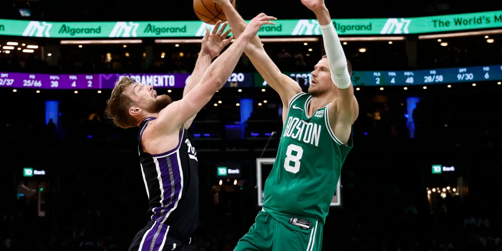 Kristaps Porziņģis (#8) cīņā par bumbu ar lietuvieti Domantu Saboni (#10).