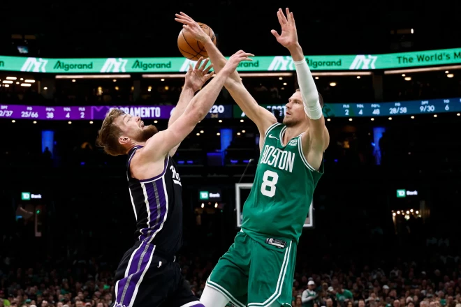 Kristaps Porziņģis (#8) cīņā par bumbu ar lietuvieti Domantu Saboni (#10).