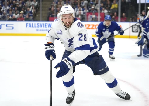 Oct 21, 2024; Toronto, Ontario, CAN; Tampa Bay Lightning forward Zemgus Girgensons (28) goes after a puck against the Toronto Maple Leafs during the second period at Scotiabank Arena. Mandatory Credit: John E. Sokolowski-Imagn Images