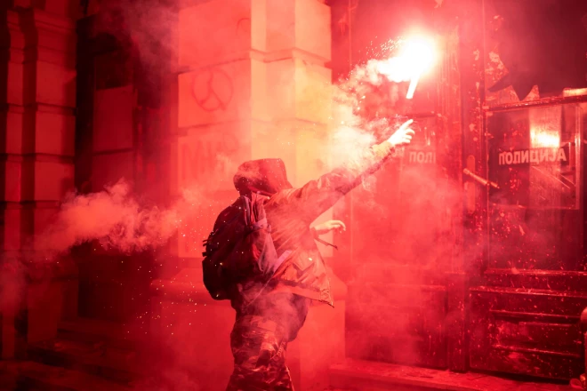 Protestētāji otrdien Novi Sadas pilsētas domes ēkai meta virsū signālraķetes un sarkano krāsu, protestējot pret iepriekšējās nedēļas notikumu.