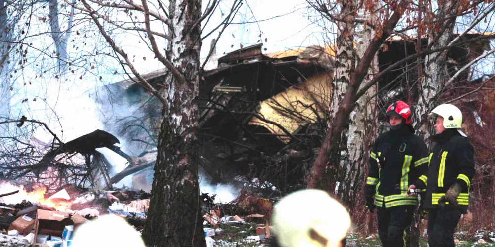 Lithuanian rescuers work next to the wreckage of a cargo plane following its crash near the Vilnius International Airport in Vilnius on November 25, 2024. (Photo by Petras MALUKAS / AFP)