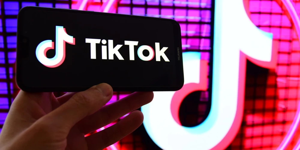 "TikTok" logotips mobilā telefona ekrānā