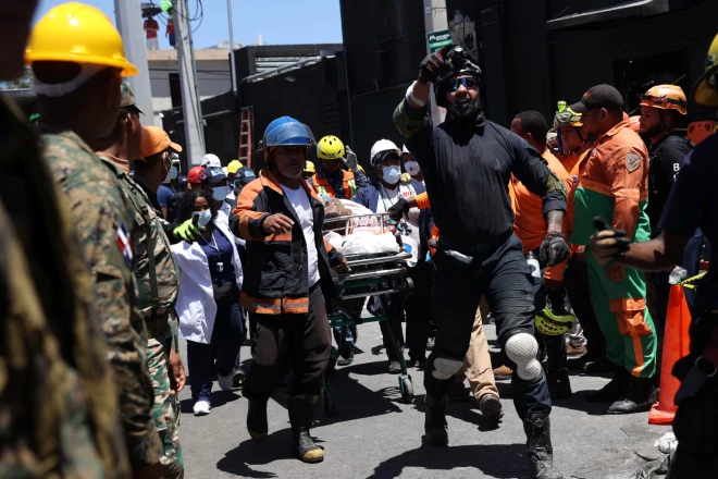 Спасатели перевозят пострадавшего, извлеченного с места обрушения ночного клуба Jet Set в Санто-Доминго.