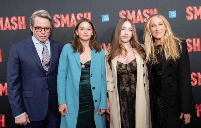 Родители с дочерьми на красной дорожке.