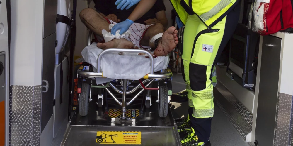 epa12214530 An injured person is treated in an ambulance by emergency workers after an explosion at a petrol station in via dei Gordiani, in Rome, Italy, 04 July 2025. At least 21 people have been injured in the explosion, ANSA reported.  EPA/MASSIMO PERCOSSI -- ATTENTION EDITORS: FACE PIXELATED AT SOURCE --