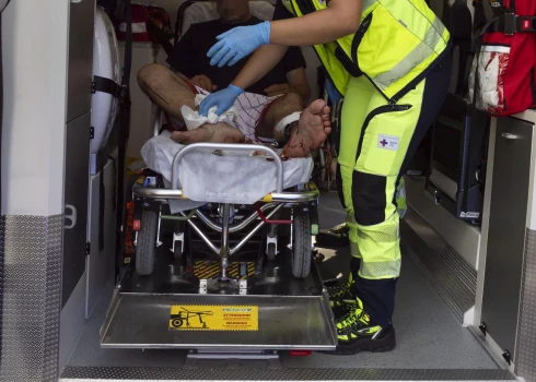 epa12214530 An injured person is treated in an ambulance by emergency workers after an explosion at a petrol station in via dei Gordiani, in Rome, Italy, 04 July 2025. At least 21 people have been injured in the explosion, ANSA reported.  EPA/MASSIMO PERCOSSI -- ATTENTION EDITORS: FACE PIXELATED AT SOURCE --