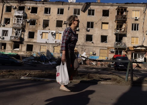  Люди ходят среди поврежденных жилых домов после российского удара в Краматорске, Донецкая область.