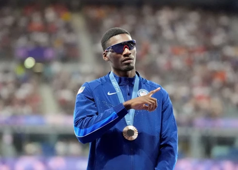 Freds Kērlis uz pjedestāla Parīzes olimpiskajās spēlēs.