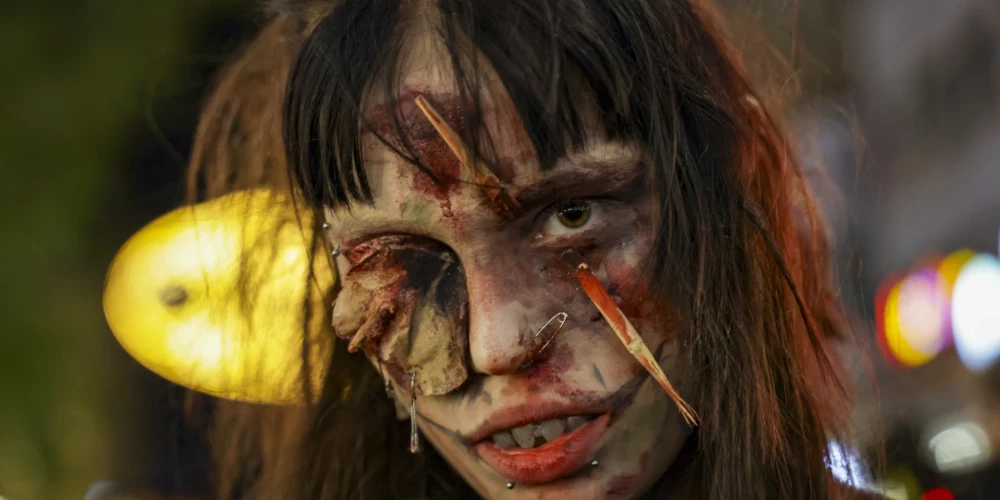 epa12495691 A person wears a costume during a Zombie Walk event in Essen, Germany, 31 October 2025, on the occasion of Halloween.  EPA/CHRISTOPHER NEUNDORF