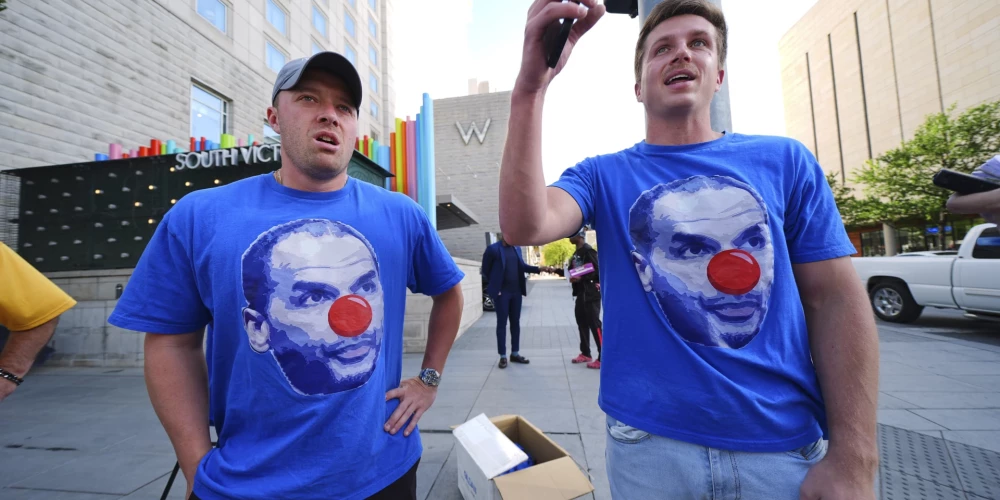 Piktie Dalasas "Mavericks" fani ar kluba ģenerālmenedžera Niko Harisona bildi ar klauna degunu