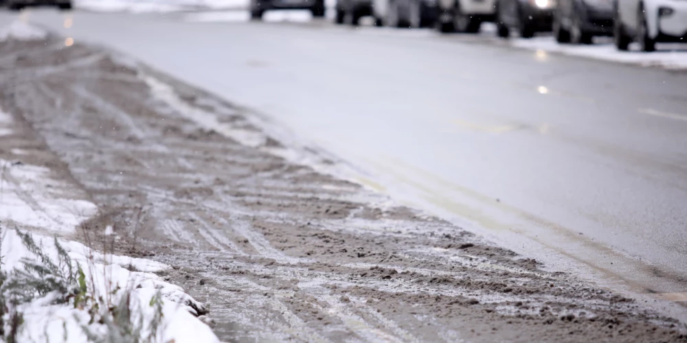 Kūstošs sniegs uz ceļa.