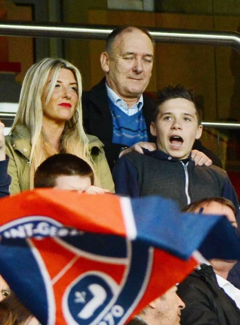 Deivida Bekhema māsa Džoanna Bekhema un Teds Bekhems ar mazdēlu Bruklinu 2013. gadā.