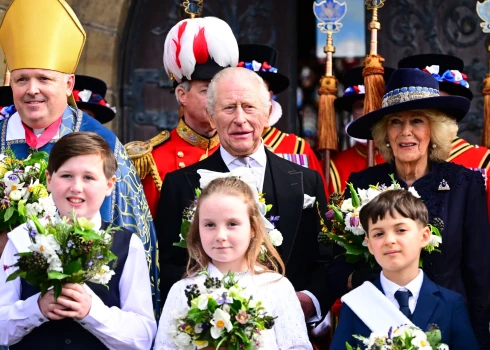 King Charles III and Queen Camilla pose with The Dean of St Asaph Cathedral, Nigel Williams, The Bishop of St Asaph, the Rt Revd Gregory Cameron and the Yeoman of the Guard, the official bodyguards of the British Monarch following the Royal Maundy Service at St Asaph Cathedral