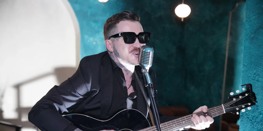 Miks Dukurs ar ģitāru pārsteidz Ēriku Ozollapu viņa jubilejā.